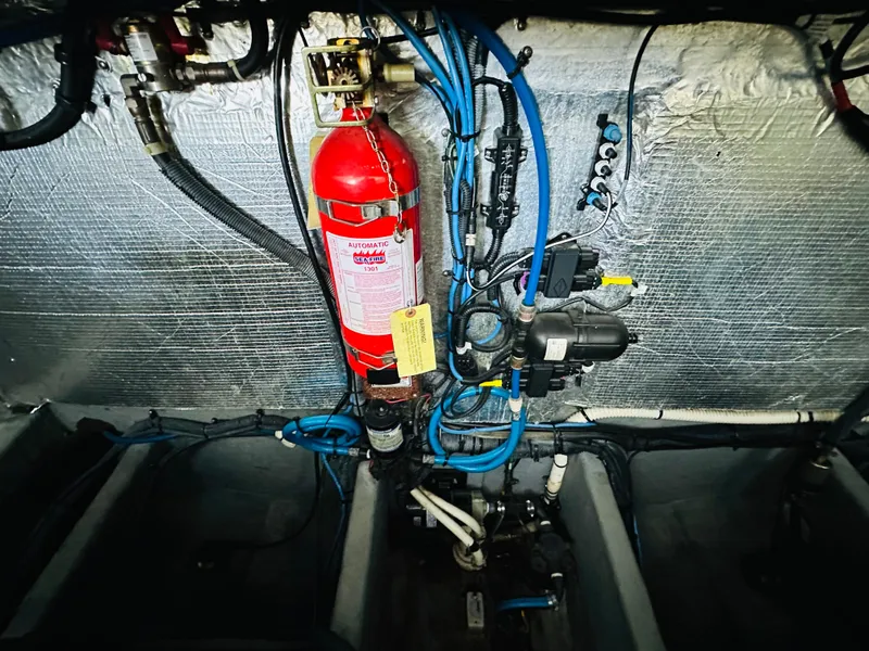 Slide: The Image of Engine room of 2002 Sea Ray 410 Express Cruiser with fire extinguisher and wiring. - 43
