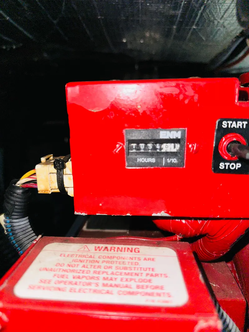 Slide: The Image of Close-up of a 2002 Sea Ray 410 Express Cruiser engine hour meter and warning label. - 46