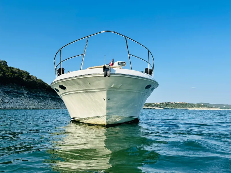 Slide: The Image of 2002 Sea Ray 410 Express Cruiser on calm water, clear sky background. - 5