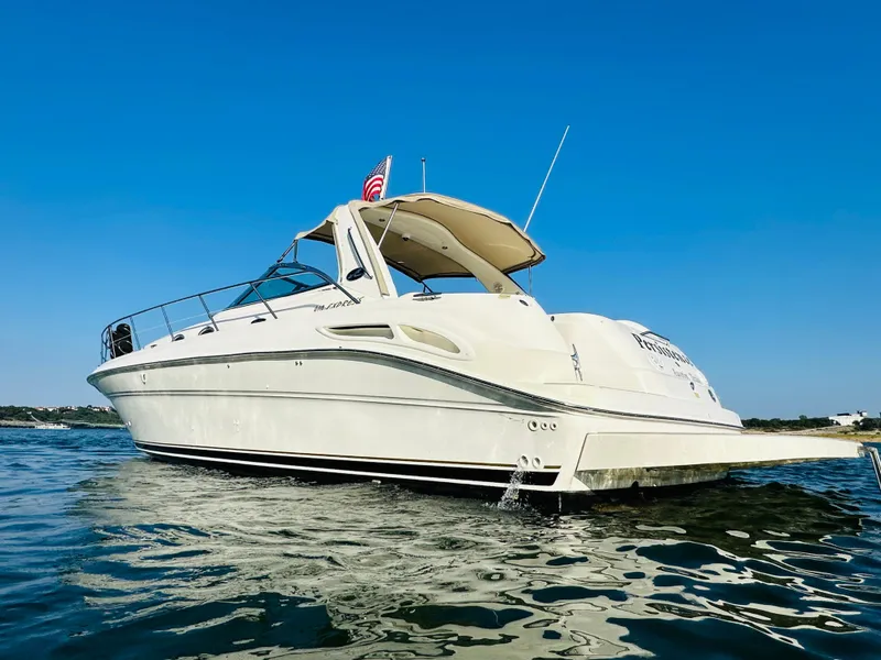 Slide: The Image of 2002 Sea Ray 410 Express Cruiser on open water under clear blue sky. - 6