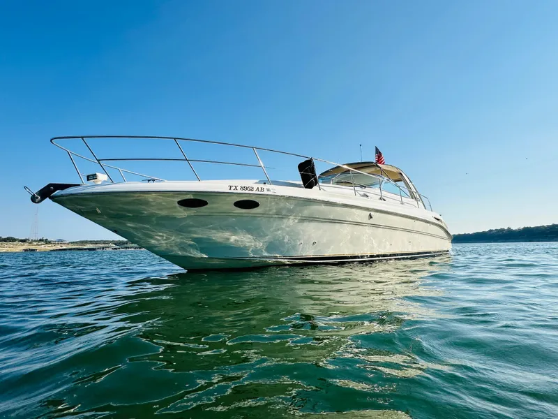 Slide: The Image of 2002 Sea Ray 410 Express Cruiser on calm water under clear blue sky. - 8
