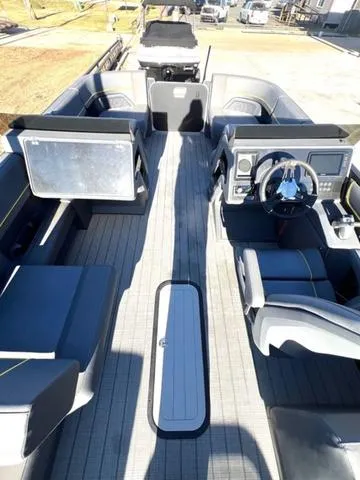 Slide: The Image of 2023 Manitou EXPLORE 22 boat interior with modern seating and steering console. - 10