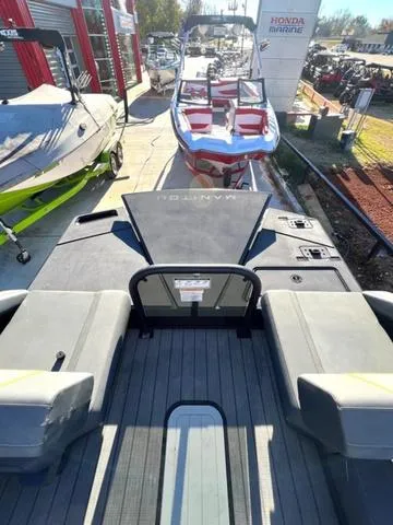 Slide: The Image of 2023 Manitou EXPLORE 22 pontoon boat displayed at a marina. - 8