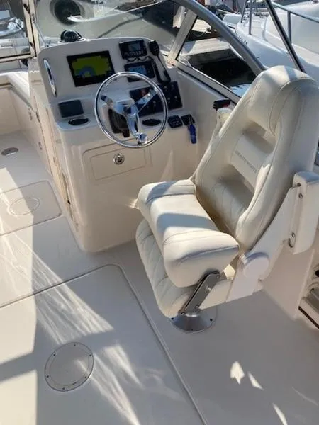 Slide: The Image of 2022 Grady-White Freedom 215 boat interior with captain's chair and control panel. - 10