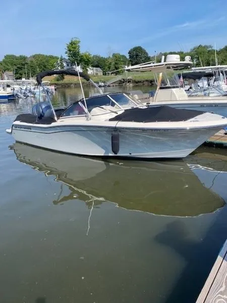 Slide: The Image of 2022 Grady-White Freedom 215 boat docked in a marina. - 13