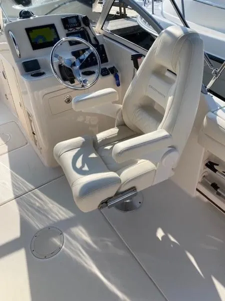 Slide: The Image of 2022 Grady-White Freedom 215 boat interior with captain's chair and control panel. - 14