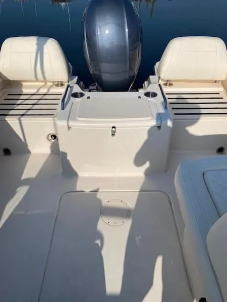 Slide: The Image of 2022 Grady-White Freedom 215 boat interior with seating and motor. - 2