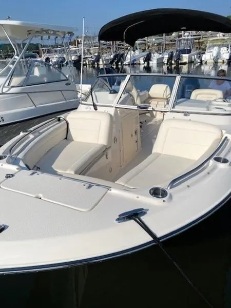 Slide: The Image of 2022 Grady-White Freedom 215 boat docked at marina, featuring spacious seating. - 7