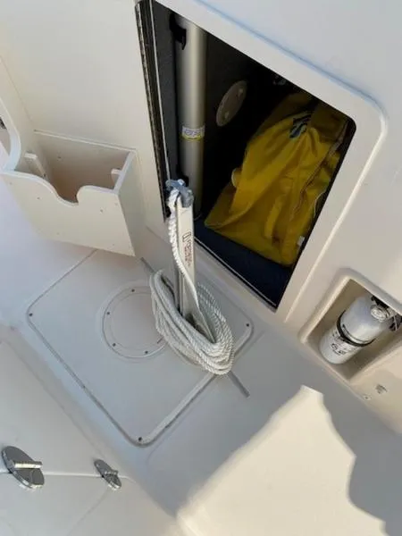 Slide: The Image of 2022 Grady-White Freedom 215 boat storage compartment with rope and safety equipment. - 8