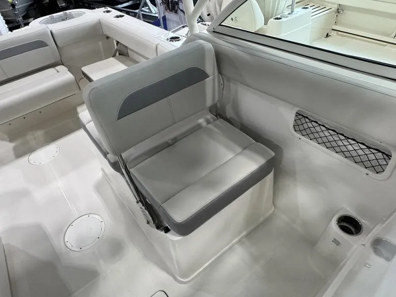Slide: The Image of 2025 Sailfish 245 DC boat interior with gray seating and storage compartments. - 10