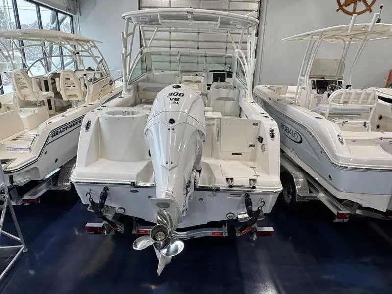 Slide: The Image of 2025 Sailfish 245 DC boat with powerful 300 HP engine in showroom. - 5