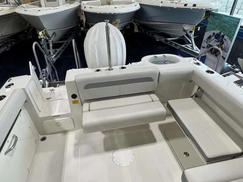 Slide: The Image of 2025 Sailfish 245 DC boat interior with seating and storage compartments. - 6