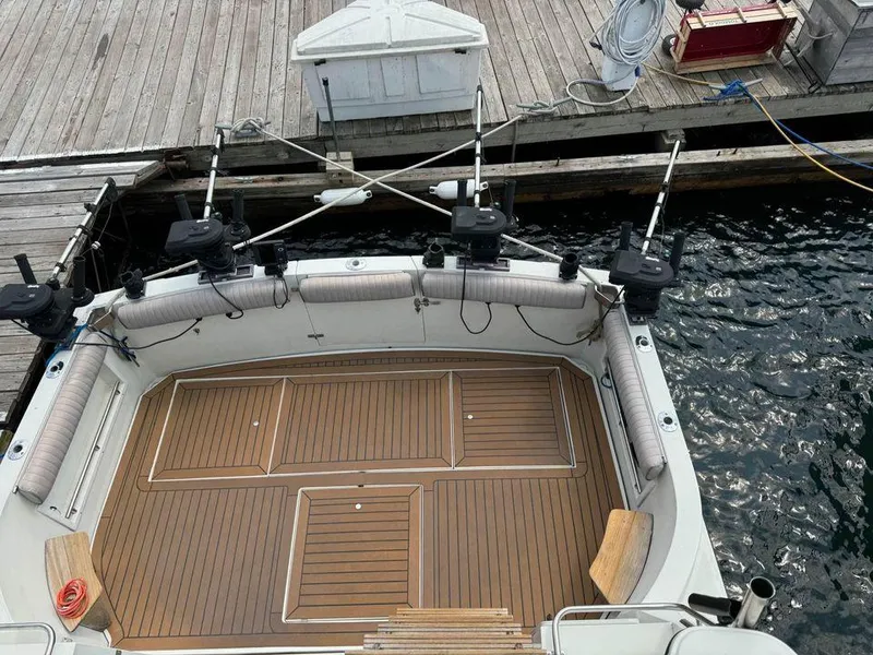 Slide: The Image of 1988 Carver 3227 boat with wooden deck, docked at a marina. - 8
