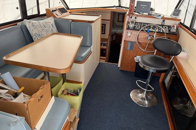 Slide: The Image of Interior of 1988 Carver 3227 Convertible boat with helm, seating, and table. - 10