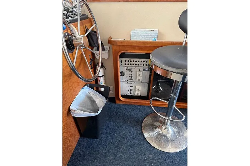 Slide: The Image of Interior of 1988 Carver 3227 Convertible with steering wheel, stool, and control panel. - 12