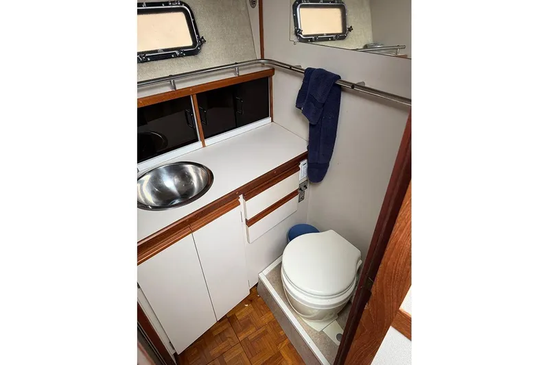 Slide: The Image of 1988 Carver 3227 Convertible bathroom with sink, toilet, and towel rack. - 15