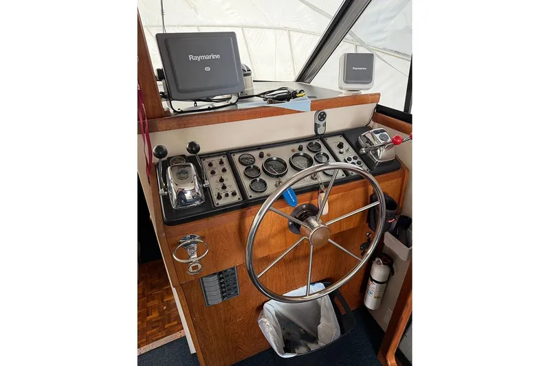 Slide: The Image of 1988 Carver 3227 Convertible helm with Raymarine navigation system and classic controls. - 20