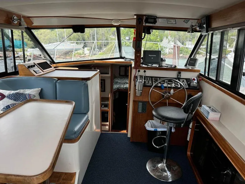 Slide: The Image of Interior of 1988 Carver 3227 boat with helm, seating, and navigation equipment. - 5