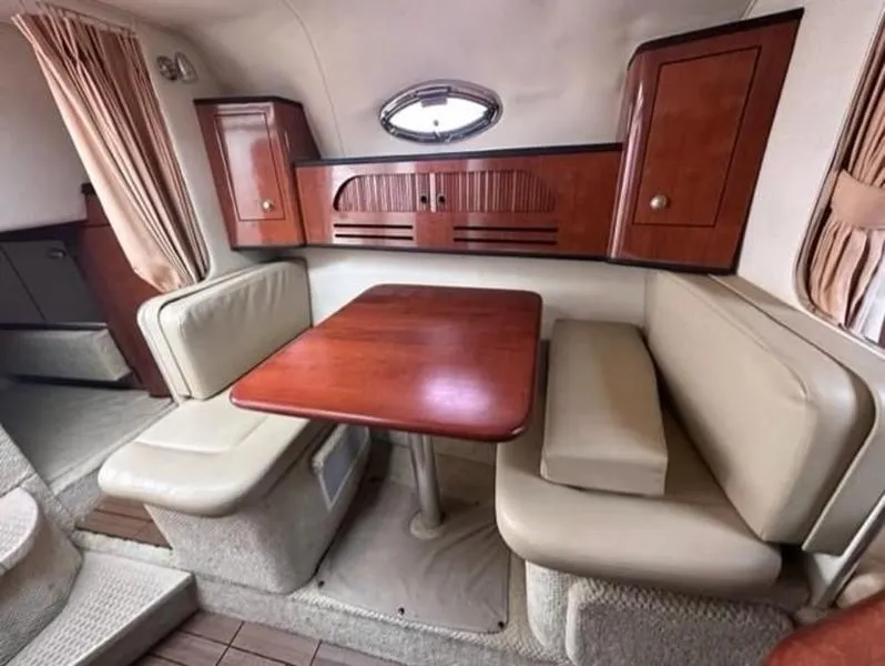 Slide: The Image of 2007 Sea Ray 280 Sundancer cabin with dining area and wooden cabinetry. - 10