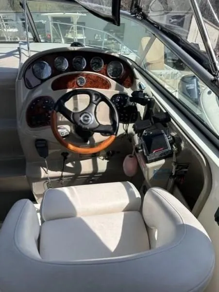 Slide: The Image of 2007 Sea Ray 280 Sundancer helm with wood accents and modern controls. - 2