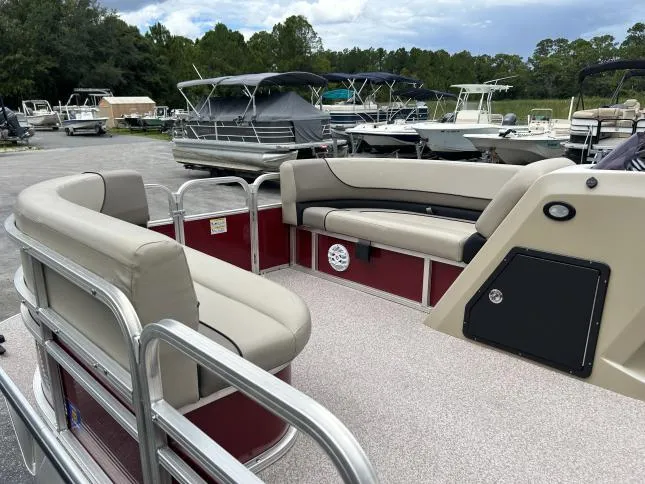 Slide: The Image of 2021 Crestliner 180 Sprint Cruise pontoon boat with beige seating, docked outdoors. - 10