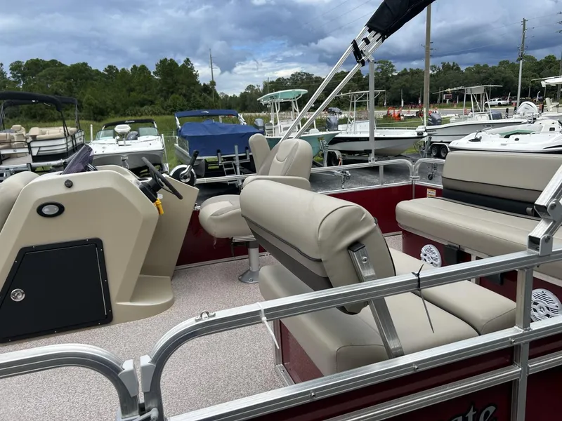 Slide: The Image of 2021 Crestliner 180 Sprint Cruise boat with beige seating, parked outdoors. - 11