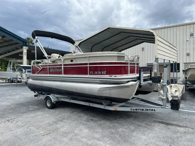 Slide: The Image of 2021 Crestliner 180 Sprint Cruise pontoon boat on trailer, parked outdoors. - 13