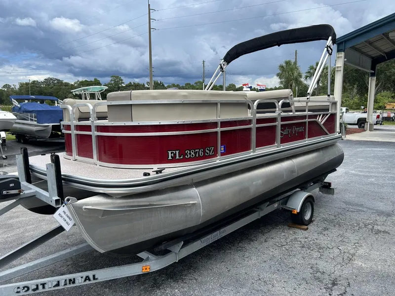 Slide: The Image of 2021 Crestliner 180 Sprint Cruise pontoon boat on trailer, red and silver design. - 3