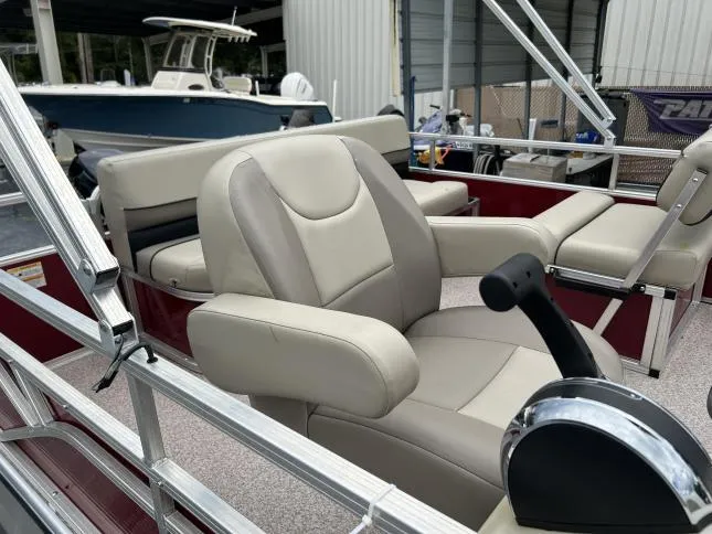 Slide: The Image of 2021 Crestliner 180 Sprint Cruise boat interior with beige seating and control lever. - 5