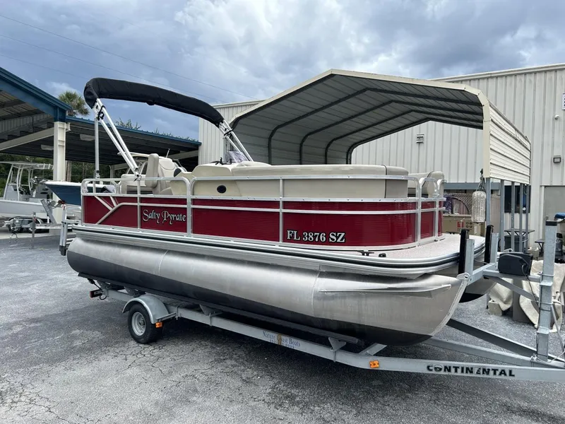 Slide: The Image of 2021 Crestliner 180 Sprint Cruise pontoon boat on trailer, red and silver design. - 6