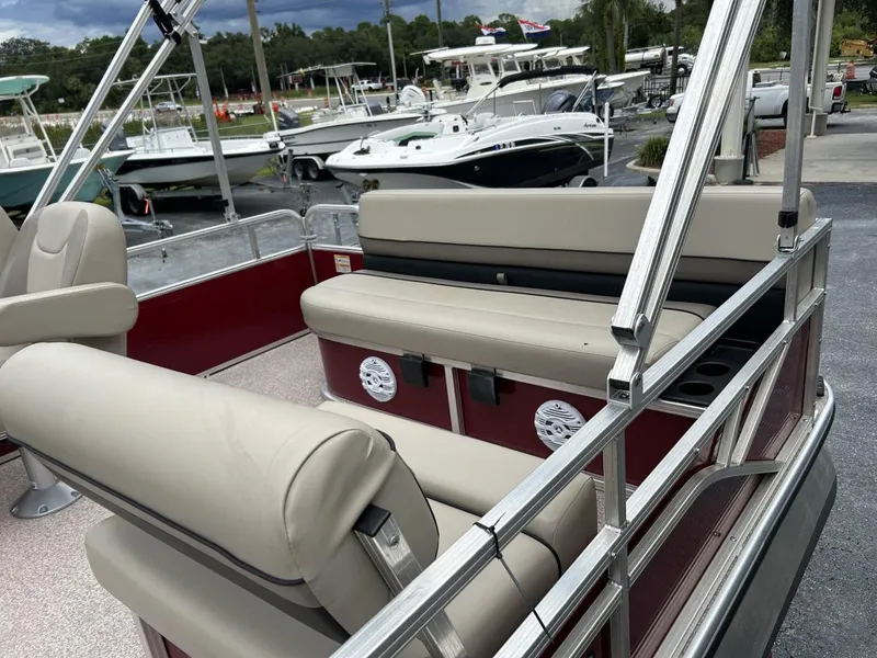 Slide: The Image of 2021 Crestliner 180 Sprint Cruise pontoon boat with beige seating, docked at a marina. - 9