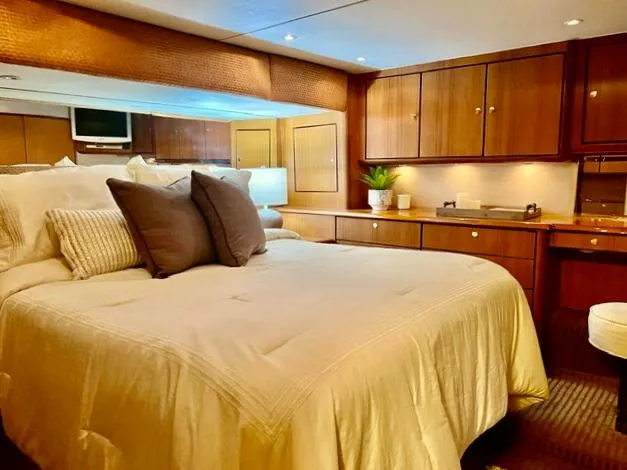 Slide: The Image of Luxurious bedroom interior of 1997 Ocean Yachts 60 Super Sport with wood cabinetry and cozy bedding. - 13