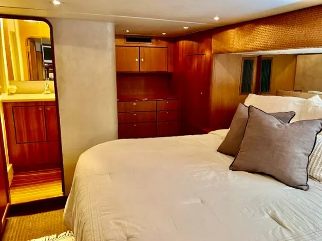 Slide: The Image of Luxurious bedroom interior of a 1997 Ocean Yachts 60 Super Sport with wood accents. - 15