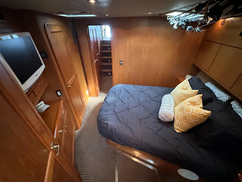 Slide: The Image of Luxurious cabin interior of 1997 Ocean Yachts 60 Super Sport with cozy bedding and modern amenities. - 19