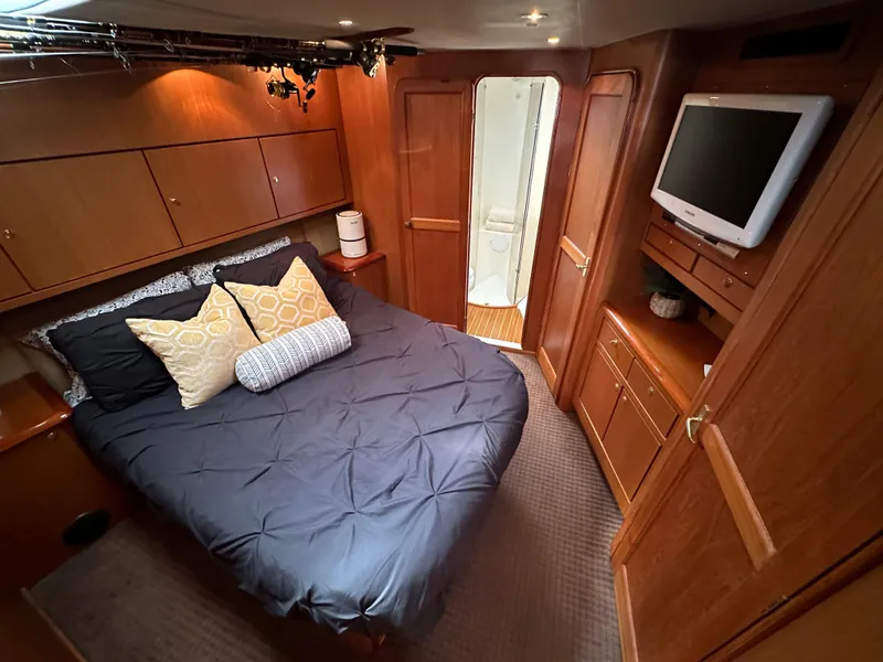 Slide: The Image of Luxurious bedroom in 1997 Ocean Yachts 60 Super Sport with TV and ensuite bathroom. - 20