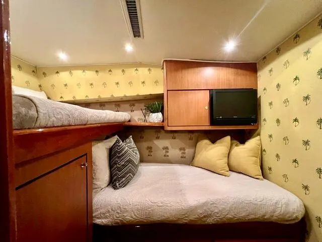 Slide: The Image of Cozy cabin interior of 1997 Ocean Yachts 60 Super Sport with twin beds and TV. - 23