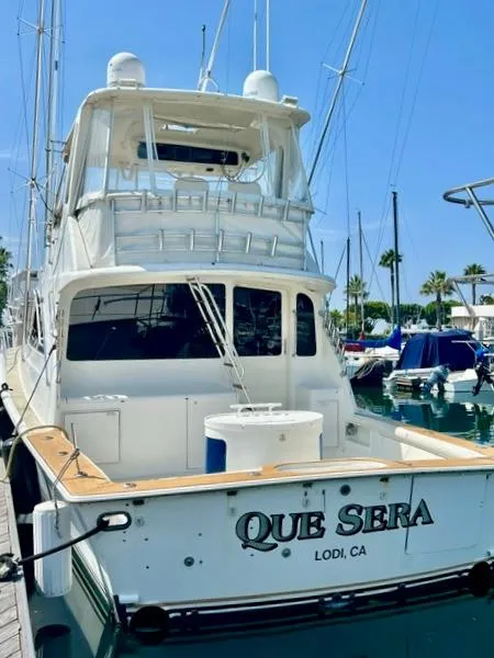 Slide: The Image of 1997 Ocean Yachts 60 Super Sport docked, rear view with "Que Sera" name visible. - 33