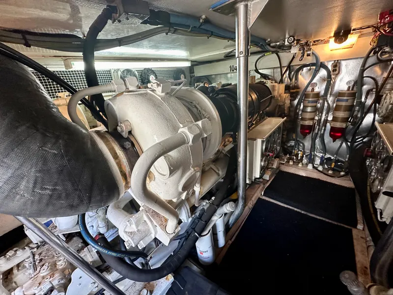 Slide: The Image of Engine room of a 1997 Ocean Yachts 60 Super Sport, showcasing mechanical components and systems. - 34