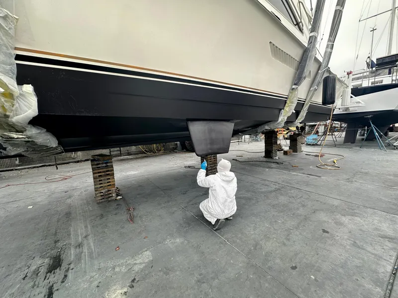 Slide: The Image of Person working on 1997 Ocean Yachts 60 Super Sport hull in a shipyard. - 37