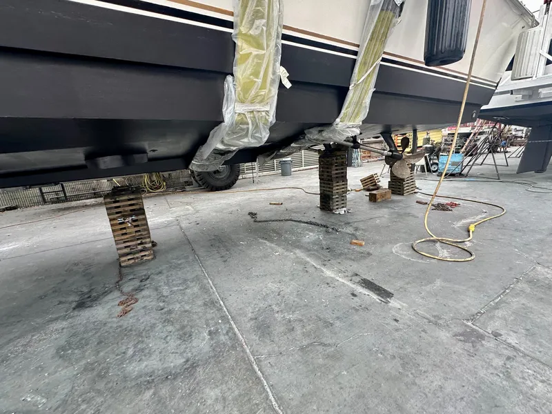 Slide: The Image of 1997 Ocean Yachts 60 Super Sport on blocks for maintenance in a shipyard. - 39