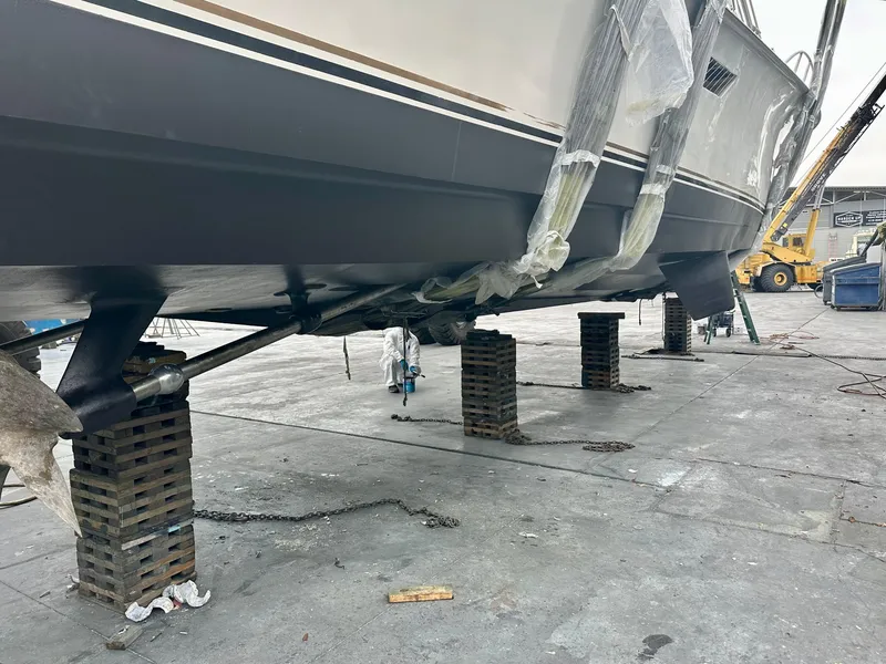 Slide: The Image of 1997 Ocean Yachts 60 Super Sport on blocks for maintenance at a shipyard. - 40