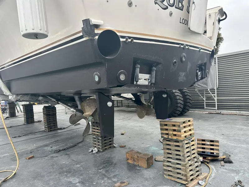 Slide: The Image of 1997 Ocean Yachts 60 Super Sport on blocks, showing propellers and hull details. - 41