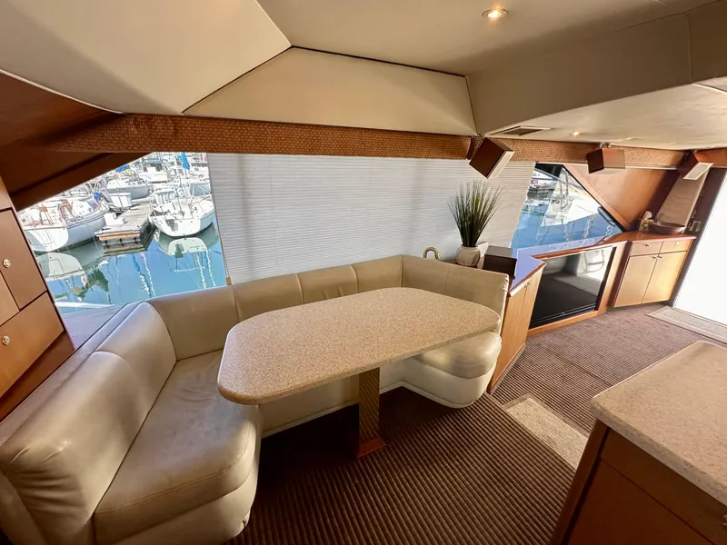 Slide: The Image of Interior of 1997 Ocean Yachts 60 Super Sport with dining area and marina view. - 8