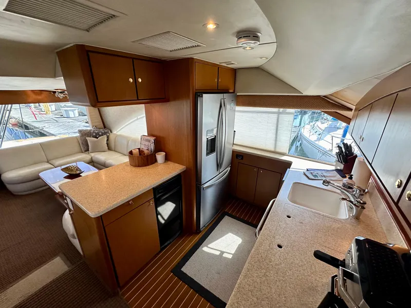 Slide: The Image of Luxurious interior of 1997 Ocean Yachts 60 Super Sport with modern kitchen and seating area. - 9
