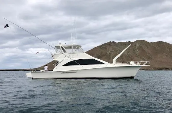 The Image of 1997 Ocean Yachts 60 Super Sport on water with mountainous backdrop. - 0