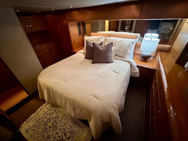 Slide: The Image of Luxurious bedroom in 1997 Ocean Yachts 60 Super Sport with elegant wood finishes. - 14