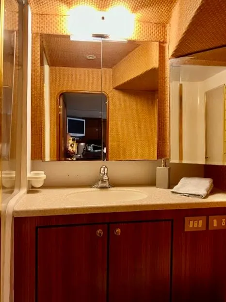 Slide: The Image of Luxurious bathroom in a 1997 Ocean Yachts 60 Super Sport, featuring elegant wood cabinetry. - 16