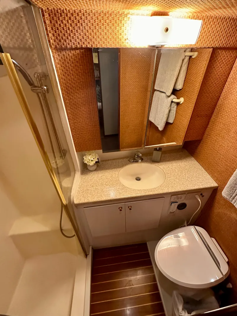 Slide: The Image of Bathroom interior of 1997 Ocean Yachts 60 Super Sport with modern fixtures and wood accents. - 25