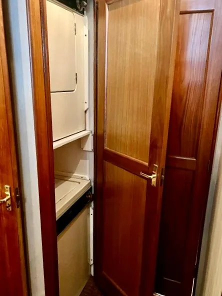 Slide: The Image of Laundry area in 1997 Ocean Yachts 60 Super Sport with wooden cabinetry. - 26