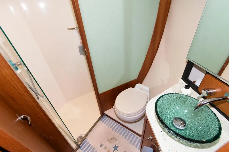 Slide: The Image of Luxurious bathroom in 2006 Tiara Yachts 4300 Sovran with glass sink and shower. - 19